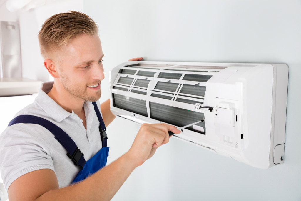 HVAC technician performing ductless air conditioning maintenance in Provo