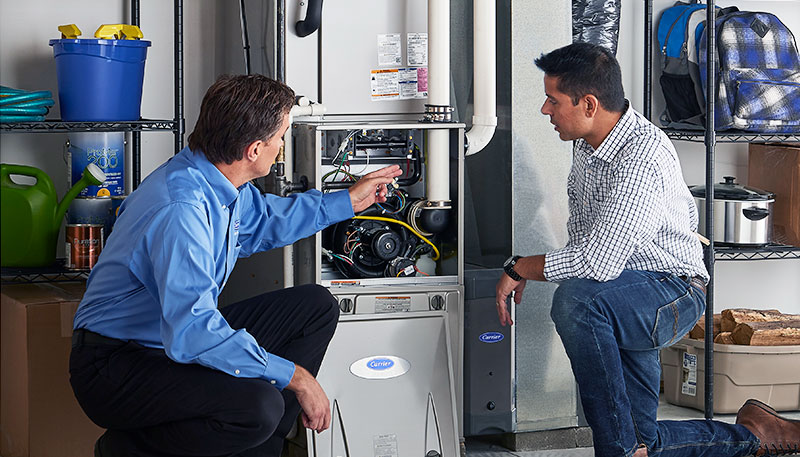 HVAC technician evaluating a furnace for repair or replacement in Provo