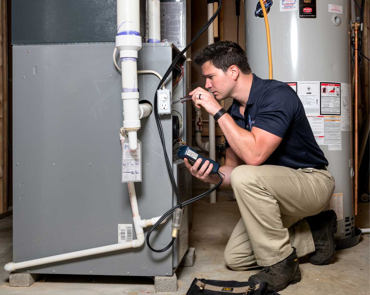 HVAC technician performing a furnace tune-up in Provo