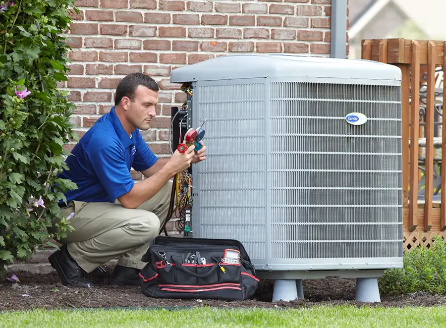 HVAC technician inspecting an outdoor air conditioning unit in Provo