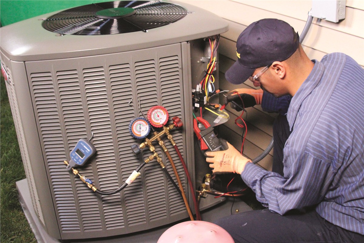 HVAC technician testing an outdoor air conditioning unit in Provo