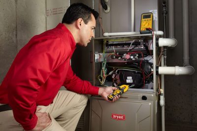 furnace repair Heating and air conditioning technician servicing an indoor furnace in Provo, UT